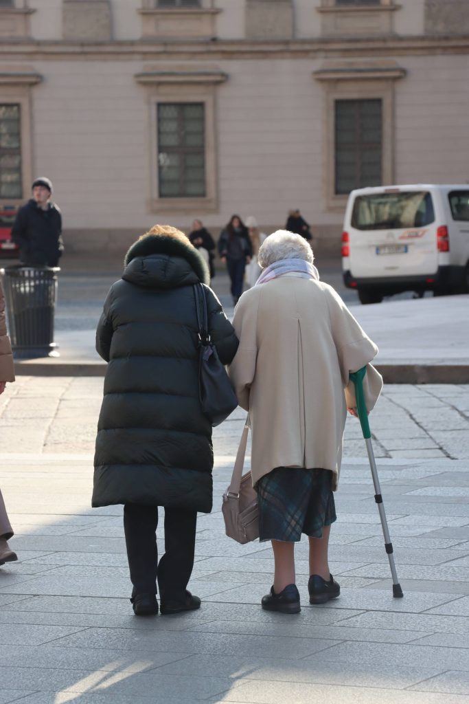 two older women about to walk across the street