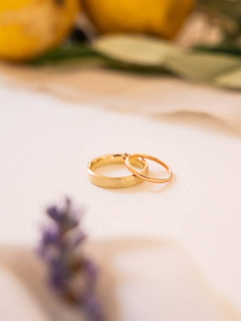 Two gold wedding rings on a surface