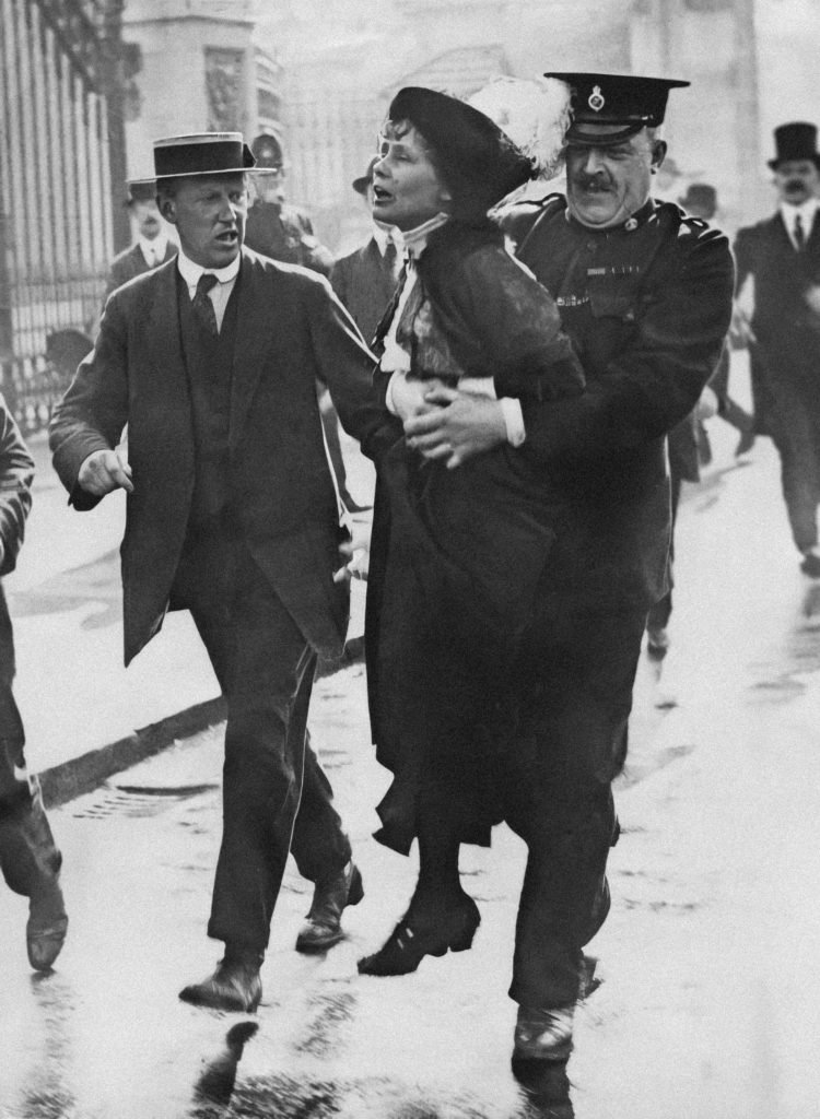 a woman held by a policeman, early 1900s